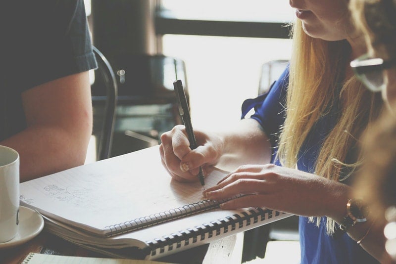 Woman Writing in Notebook