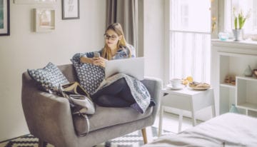 woman reading new about student loans