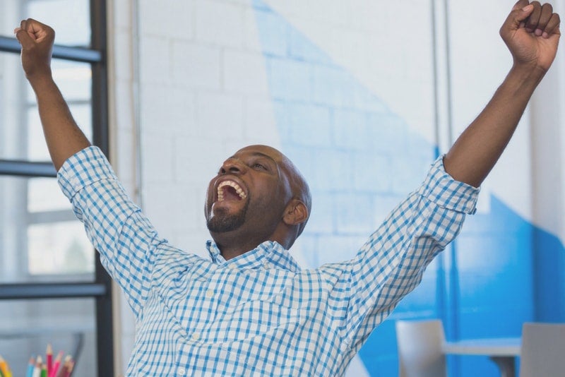 Man enthusiastically cheering how ELFI saved him money