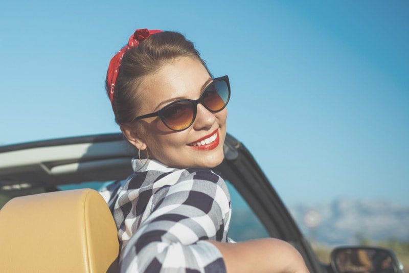 Woman sitting in her new convertible