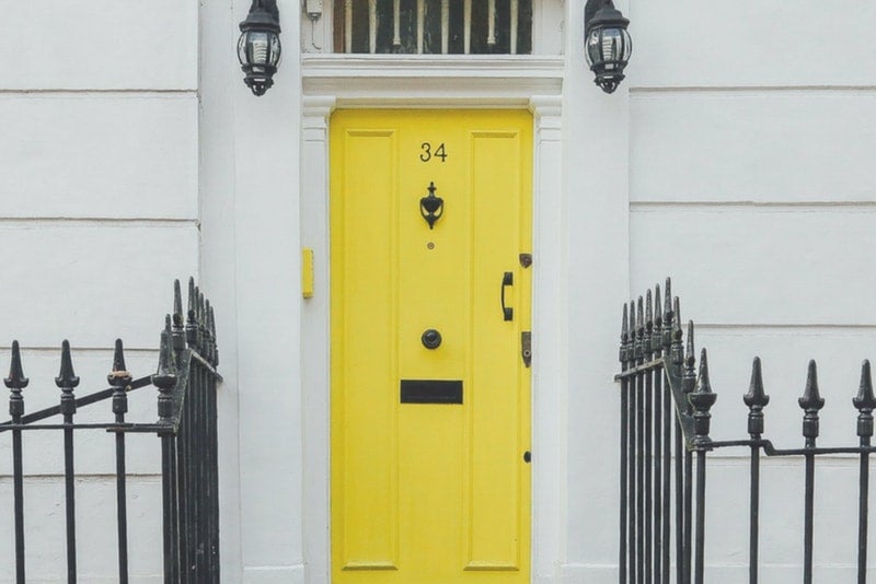 Yellow front door of a home