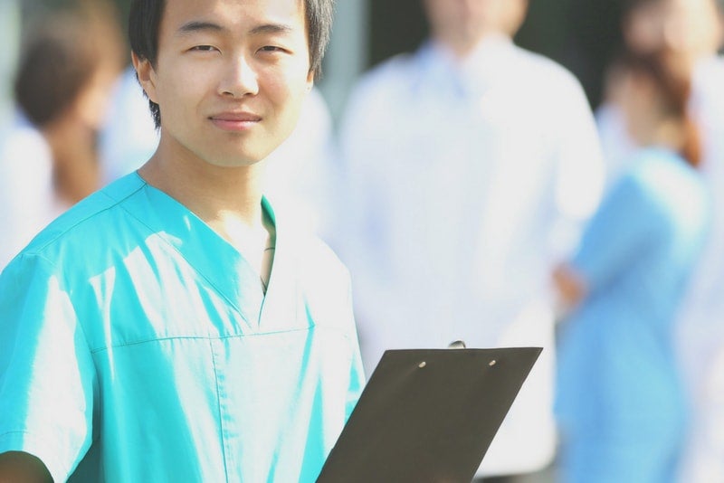 Medical resident holding a clipboard