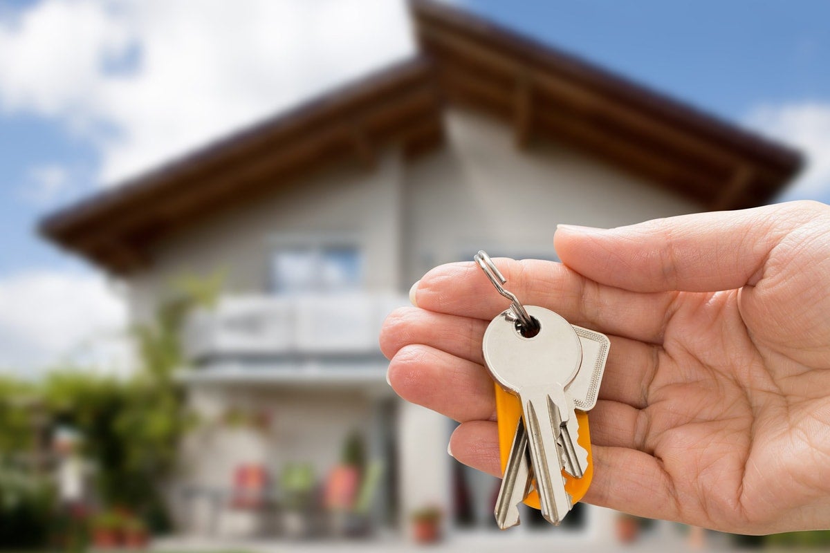 Hand holding the keys to a new home