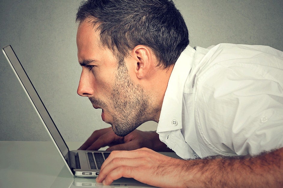 Confused man trying to do his taxes on a laptop