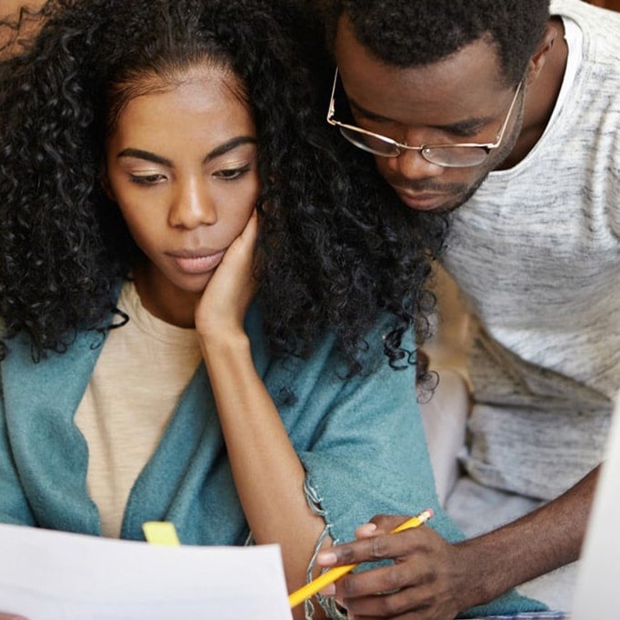 Man helping woman with student loan debt calculations