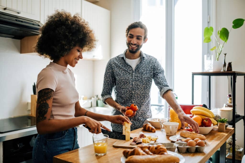 Multi ethnic couple in kitchen preparing food