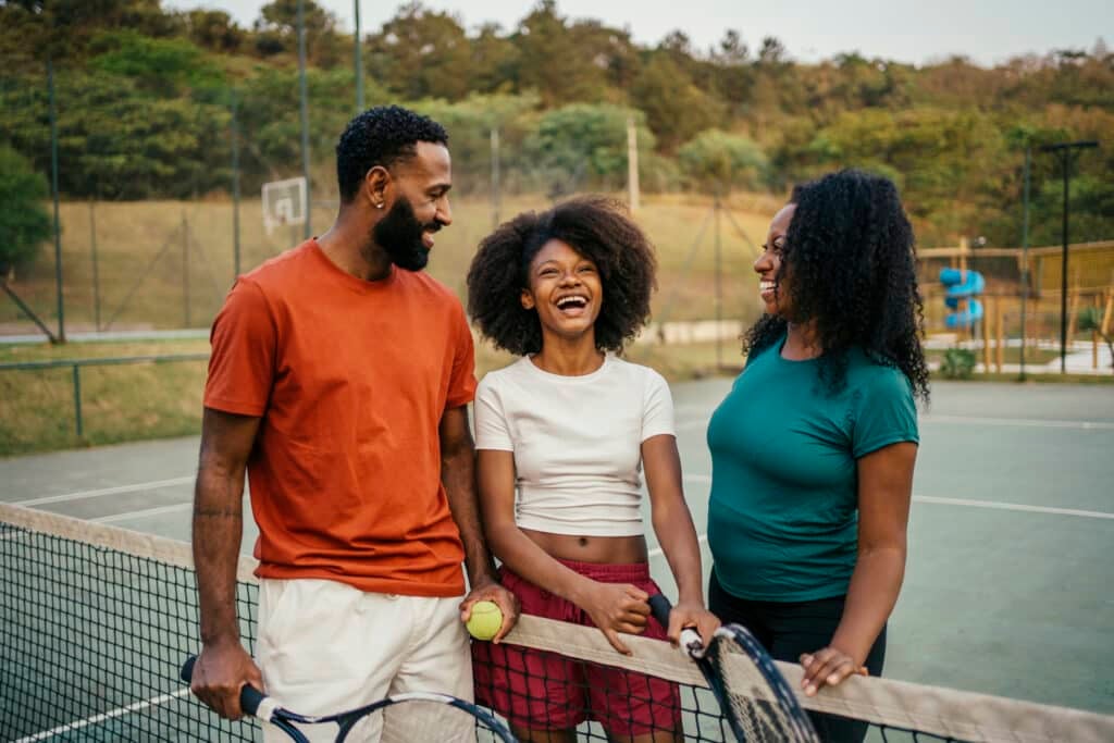 Portrait of father and daughter at tennis court