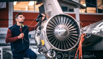 Engineer working on plane propeller