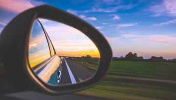 looking back in rear view mirror