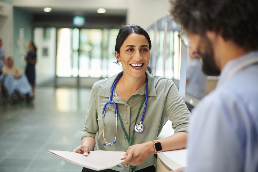 Hospital doctor talking to colleague