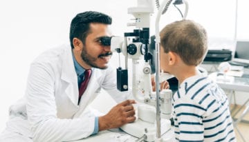 ophthalmologist working with patient