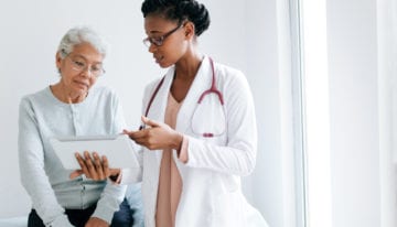 doctor with student loan debt working with a patient