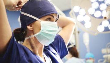 healthcare professional putting on mask
