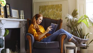 Millennial reading in living room