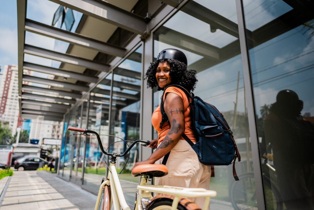 Portrait of a mid adult woman walking with her bicycle outdoors