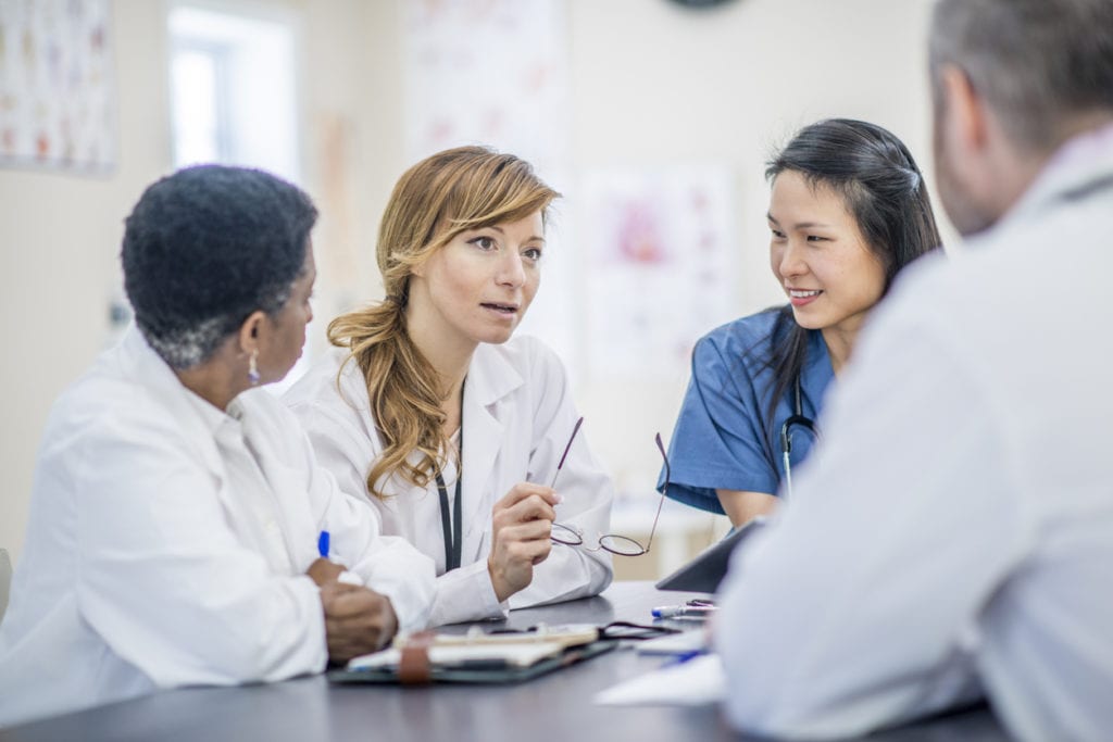 Team of medical students in residency considering refinancing student loans