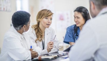 Team of medical students in residency considering refinancing student loans