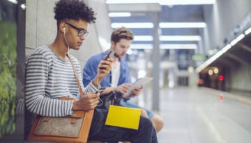 millennial reading about creative ways to save money and pay off student loans.
