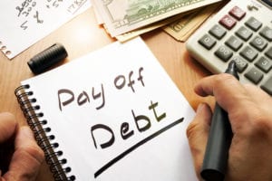 note saying pay off debt