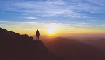 man standing on mountain top