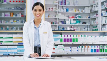 pharmacist smiling after refinancing student loans