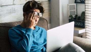 Man feeling overwhelmed by student loans