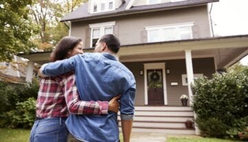 Happy couple admiring their home