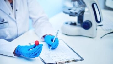 Medical professional holding test tube