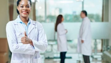 Woman in medical school giving a thumbs up