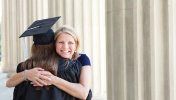 Parent with PLUS Loans hugging her graduate