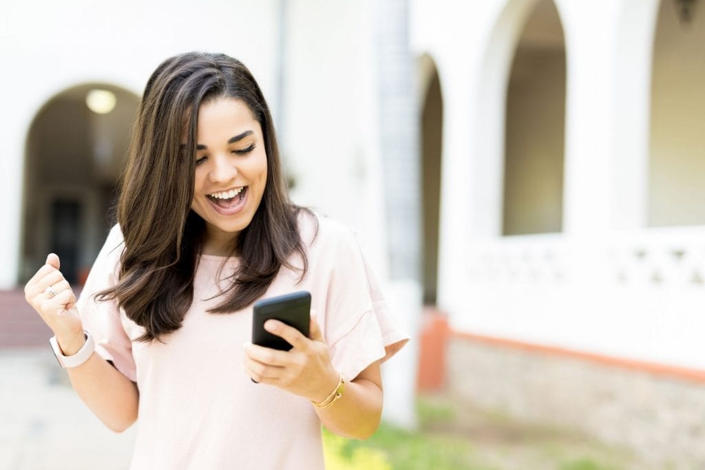 Woman celebrating after getting a scholarship