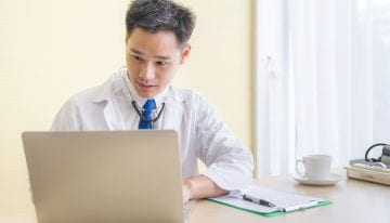 male doctor on laptop