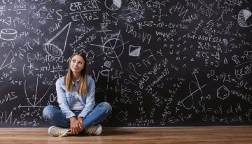 young female student in front of blackboard