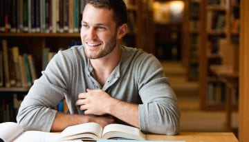 College student reading a personal finance book