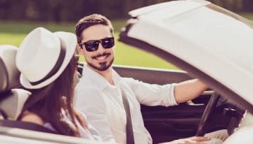Young couple in convertible experiencing lifestyle inflation