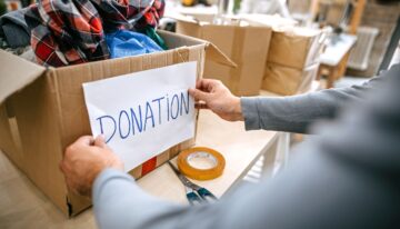 Man putting donation label on box