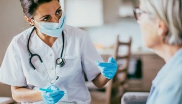 Nurse with forgiven student loans treating patient