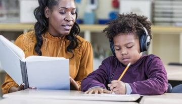 Teacher with forgiven student loans working with student