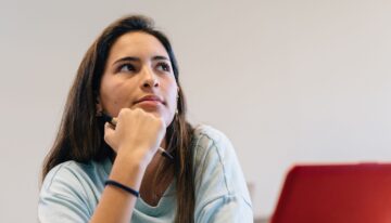 Woman wondering what happens to student loans if you drop out
