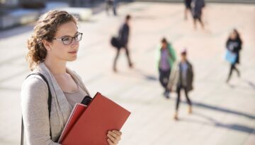 young woman holding paperwork