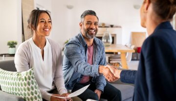 Multiethnic couple meeting with consultant at home