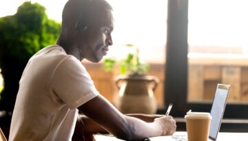 african american using laptop for masters program