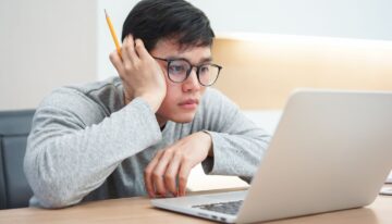 asian student using laptop