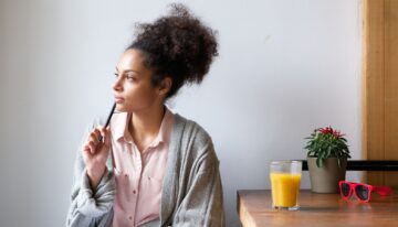 Young woman with pen and paper