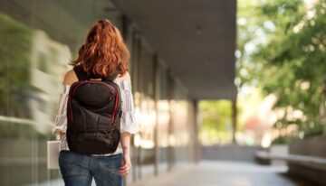 young female university student with backpack