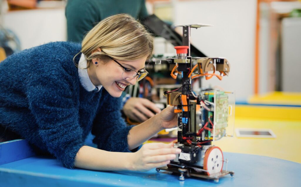 Young woman engineer working on robotics project