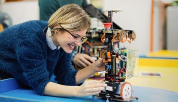Young woman engineer working on robotics project