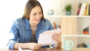 Woman reading a letter at home