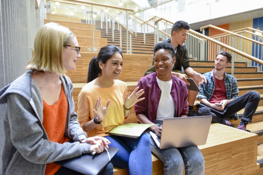 Students discussing the average college debt statistics