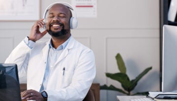 Man listening to a podcast about personal finance for doctors